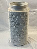 Front view of tall cylindrical vase showing overall shape and pattern