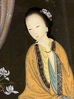 Close-up of the painted Asian woman in traditional dress showing detail in her face, hair ornaments, and robe patterning.