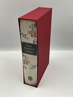 Red slip case housing the book with spine label visible.