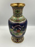 Front view of vase showing flared neck, bulbous body and pedestal base