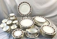 Multiple plates, cups, saucers and bowls arranged together showing full set