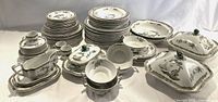 Overall assortment of Spode plates, bowls, cups, saucers, and serving pieces on white background.