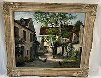 Frontal view of painting in ornate carved wood frame with whitewash finish