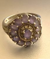 Close-up photo showing the oval amethyst stones set to form a flower motif on the sterling silver band