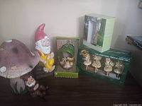 Overview of all items including two gnomes, large mushroom, small mushrooms in box, and packaged gnome figure