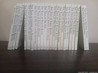 Photo of the set of Beatrix Potter books arranged standing upright showing spines and titles