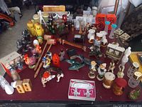 Wide view of entire assortment of vintage salt and pepper shakers showing diverse styles and materials.