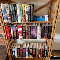 Full view of three shelves of hardcover Stephen King books with dust jackets plus one softcover book.