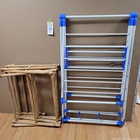 Wooden and plastic drying racks in a folded position showing structure and condition.