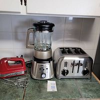 Full lot display of 3 appliances on counter including toaster, blender, and hand mixer with beaters