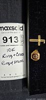 Photo of the lot with MaxSold tag noting '10k Ring + Cross, Rings w/Stone'.