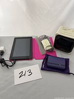 Overall lot of Amazon Kindle, Sony clock radio, and Halo charger with accessories.