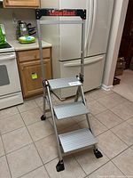 Full view of the 3-step aluminum Little Giant R6 step stool with visible black tool tray and rubber feet on tiled floor