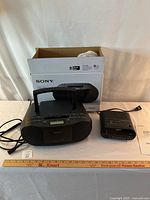 Sony portable CD boombox with original box and power cord, featuring carry handle and multiple control buttons.