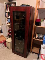 Front three-quarter view of wine cellar showing exterior wood-look finish and tinted glass door.