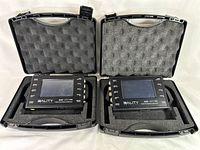 Two 3ality 3FLEX SPC-7000 stereo platform controllers placed inside foam cutouts of their protective hard cases shown with lids open.