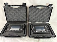 Two 3ality Digital 3Flex SPC 7000 stereo platform controllers placed side by side inside their original black foam-padded carrying cases with handles and secure latches.