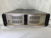 Front view of the closed 2U Magnum Box server showing ventilation grills, power switch, and USB port.