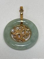 Front view of jade disc, gold dragon motif and pearl accent