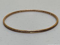 Top view of gold bangle showing diamond channel setting