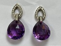 Front view of both earrings showing teardrop amethyst and diamond-set tops