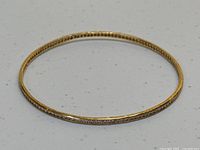 Top view of bangle laid flat on white surface