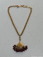 Full view of bracelet laid flat, showing chain and pendant