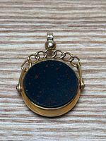 Top view showing bloodstone side of the rotating disc within the 9K gold case