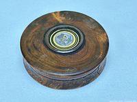 Top view of closed walnut burl snuff box showing lid and inset painting