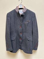 Full front view of blazer hanging on hanger