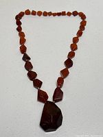 Full view of the entire necklace laid flat on white background