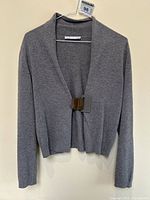 Full front view of cardigan on hanger