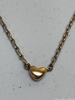 Close-up of heart pendant and adjacent chain links