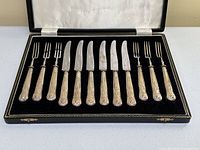 Full set of six forks and six knives displayed in original black fitted case.