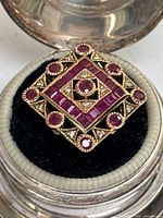 Top view of ring showing square geometric arrangement of rubies and diamonds