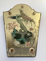 Full front view of mirror showing hand-painted mermaid design on gold-tinged glass and four glass rosettes