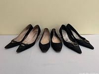 Front view showing three pairs: suede kitten heels, quilted flats, canvas kitten heels