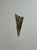 Front view of triangular artisan pendant with iridescent ammolite-like enamel pattern in green, gold, and red hues.