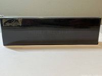 Closed black presentation box with faint Pierre Belvedere branding, shows some wear.