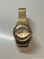 Front view of the vintage TIMEX gold plated men's mechanical watch showing the dial with Arabic numerals and date window at 3 o'clock.