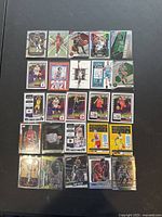 Photo showing 25 basketball trading cards laid out in neat rows, featuring various players and designs predominantly from modern NBA series.