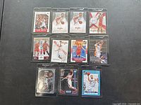 Full layout of 11 Blake Griffin basketball cards in protective sleeves on dark surface