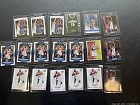 Overview of 19 Greg Monroe basketball cards, including premium editions and Milwaukee Bucks jersey patch card in protective case