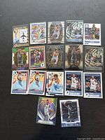 Seventeen premium Ja Morant basketball cards arranged on dark surface showing card designs with holographic and foil features.