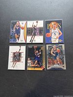 Photo of six Jason Kidd basketball cards in various poses and team jerseys on black background