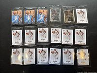 Eighteen Kevin Durant basketball cards arranged in three rows on a dark surface showing multiple duplicates of three card types.