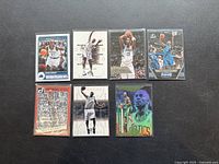 Photo showing 7 Kevin Garnett basketball cards, varying designs and teams including Timberwolves and Celtics.
