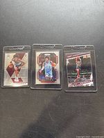 Three Kevin Porter Jr. basketball cards in clear Ultra Pro protective sleeves, displayed side by side on a black surface.