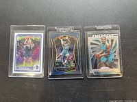 Three P.J. Washington Jr. basketball cards displayed in clear protective sleeves, showing front artwork and player imagery.