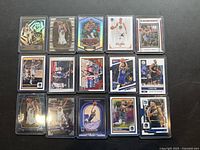 Top view of 15 Stephen Curry basketball cards laid out, showing front face designs including holographic, foil finishes, and various artistic player images.